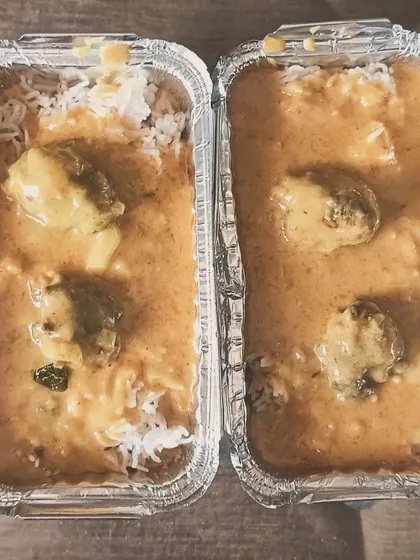 A combo of Lauki Kofta curry with rice. The soft koftas in a light gravy are a healthy and tasty option.