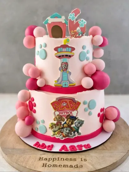 A two-tiered Paw Patrol cake for a 6th birthday. This 2.5kg Chocolate Mousse cake is decorated in shades of pink with the heroic pups.