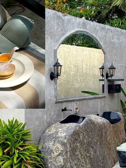 A unique outdoor sink carved from a large rock, part of a serene resort experience near Pondicherry.