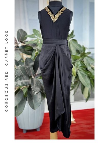 Red carpet moments aren't just for grown-ups. This gorgeous black draped dress with a gold embellished neckline brings a touch of sophisticated glamour for a stylish young lady.