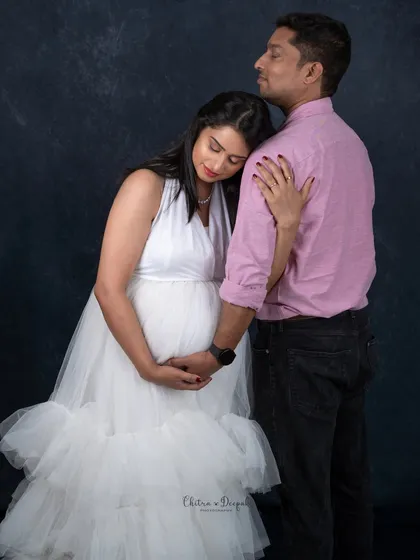 A quiet moment of comfort and support. This pose beautifully captures the protective and loving nature of the partnership during pregnancy.