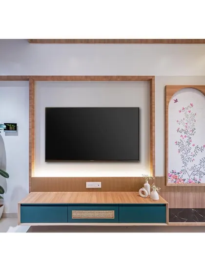 A minimalist TV unit with a beautiful hand-painted art panel beside it. The design combines clean lines with artistic, personal touches.