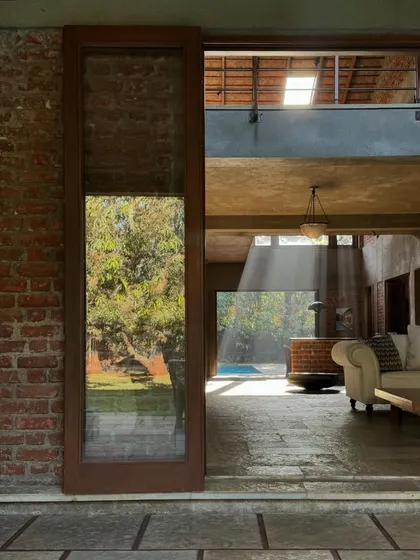 A quiet moment at The Mango House, where a beam of light cuts through the space. The design plays with light and shadow, using skylights and large openings to create a constantly changing atmosphere throughout the day.