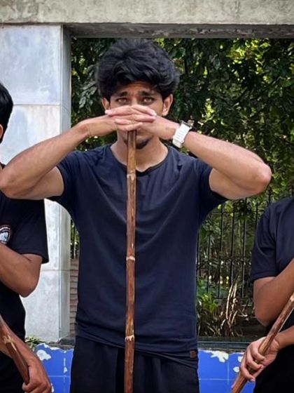 A close-up of me demonstrating the correct grip and focus during Bo Staff practice.