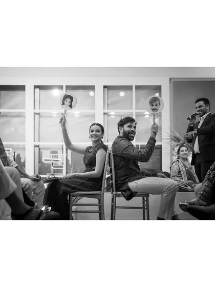 Nishna and Armaan play the shoe game, a fun and interactive part of their celebration. It’s a great way to capture candid reactions and laughter.