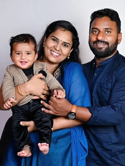 A classic family portrait with a happy, smiling baby. These are the photos that will be framed and cherished for years to come.
