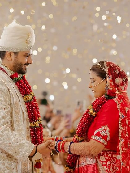 A beautiful moment of connection between the couple after the Varmala, under a sky of glittering lights. These are the memories that last a lifetime.