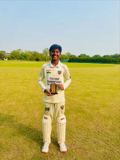 Ekansh proudly holding his Player of the Match trophy. A smile that shows the satisfaction of a job well done.