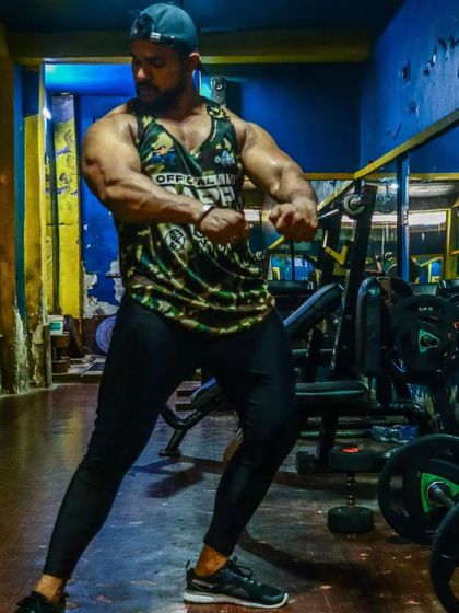 A side chest pose showing the muscle and power built through years of dedicated training.