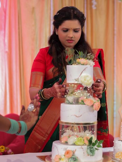 I even baked my own engagement cake. Here I am, setting up the multi-tiered cake on my special day, combining my passion with my personal celebration.