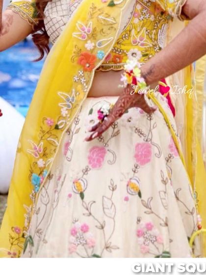 A close-up of the bride's lehenga and the custom floral hathphool I designed for her.