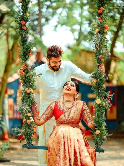 Vivek and Shivani share a joyful moment on a flower-adorned swing during their unique Mantra Mangalya wedding. I am experienced in capturing diverse ceremonies that reflect your personal values.