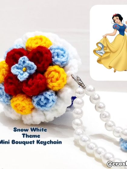 A special Snow White themed mini bouquet keychain, using her signature colors of red, yellow, and blue.