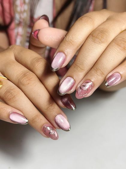 Another angle of the pink and mauve cat eye set, showing how the light catches the magnetic polish differently. The silver chrome tips add a modern and elegant touch to the design.