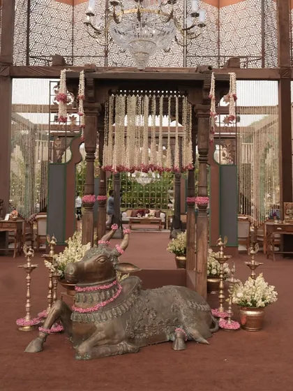 A grand entrance guarded by a beautifully adorned Nandi sculpture. This blend of traditional symbolism and opulent decor creates a powerful and auspicious welcome.