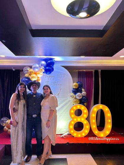 The guest of honor with his daughters, capturing a precious family moment in front of the decor we created.