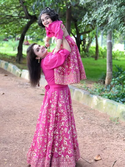 That special bond between a mother and child is something we love to capture. This joyful outdoor photo in matching outfits is a beautiful memory of their connection.