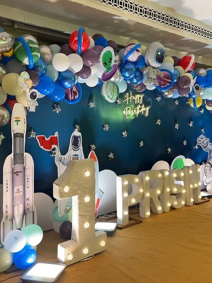 A side view of the space-themed stage, highlighting the large marquee '1' and a rocket ship prop ready for takeoff.