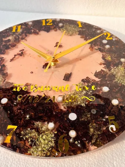 Another view of the clock made from the 1.5-year-old garland. The contrast between the dark petals and the bright yellow numbers is really eye-catching.