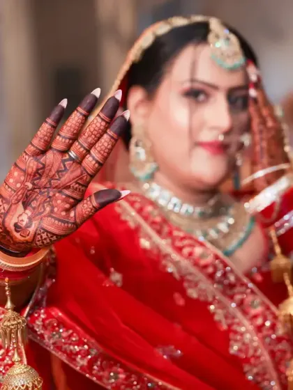 A close-up of the bride's hand, showing the beautiful stain of the mehandi. The dark color is a sign of deep love.