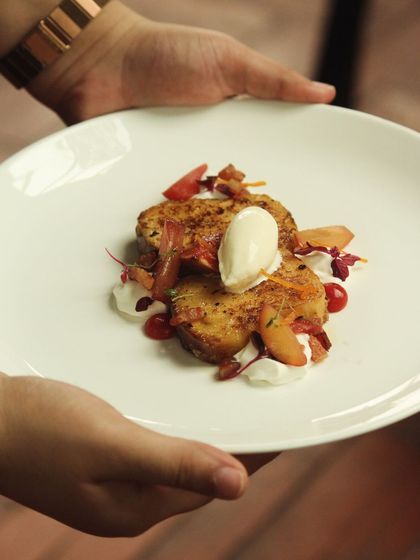 A guest enjoying a plate of my Bacon Pain Perdu at a brunch pop-up. These events are a great way to connect with the local food community.