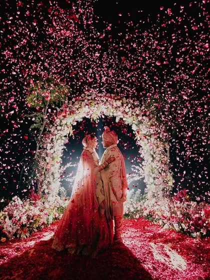 This is the moment it all leads to. We orchestrate these epic, fairytale frames, like this stunning floral shower, to create a memory that feels as grand and magical as the love it celebrates. A perfect shot for a perfect wedding day.