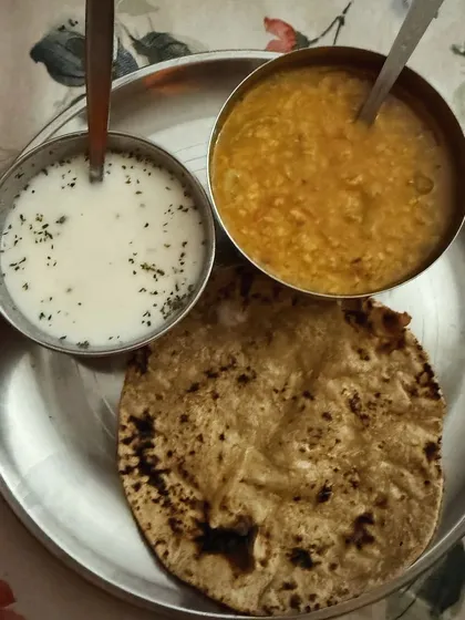 A traditional thali with dal, roti, and curd. This is a staple in many of my home-based diet plans, providing a balanced mix of nutrients.