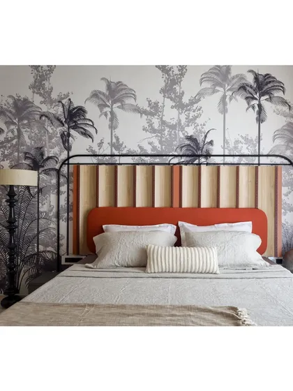The full view of the master bed, where the custom tropical wallpaper creates a stunning and immersive backdrop. The space feels like a private, tropical getaway.