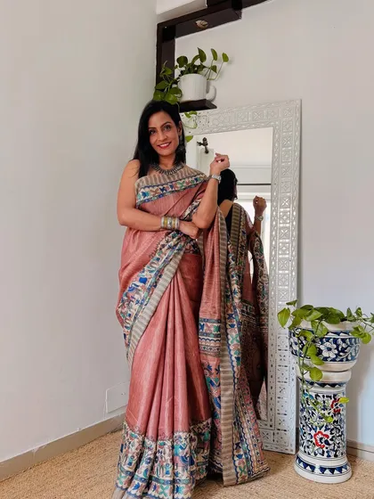 A beautiful dusty pink saree with a detailed digital print border. The soft color and intricate design make it a sophisticated choice for the office.