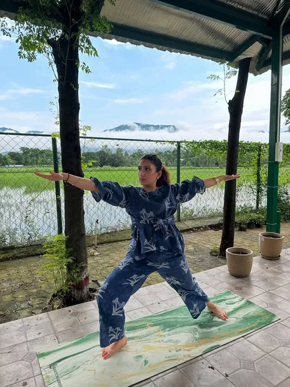 Here I am in the Warrior II pose, feeling grounded and expansive with the mountains and paddy fields as my witness. My retreats are all about finding these moments of connection between your body, your breath, and the incredible nature around us.