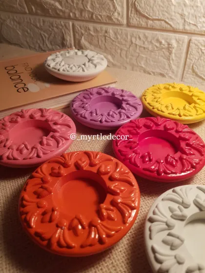 A vibrant array of our ornate diya holders, shown here unlit to highlight the variety of bright, festive colors we offer. We can customize these in any shade you like.
