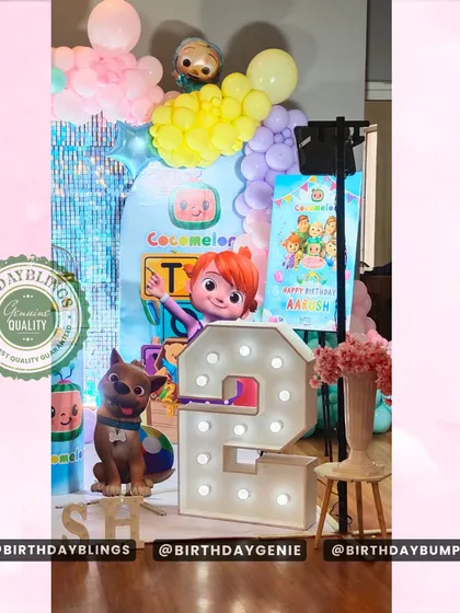 This view highlights the light-up number '2' and the placement of the character cutouts in the Cocomelon party setup.