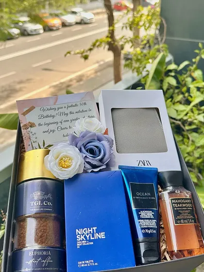 We designed this sophisticated birthday hamper for men, featuring a Zara wallet, TGL coffee, a full-size Zara perfume, and Bath & Body Works grooming products. It's a perfect blend of style and practicality, all presented in a sleek black box.
