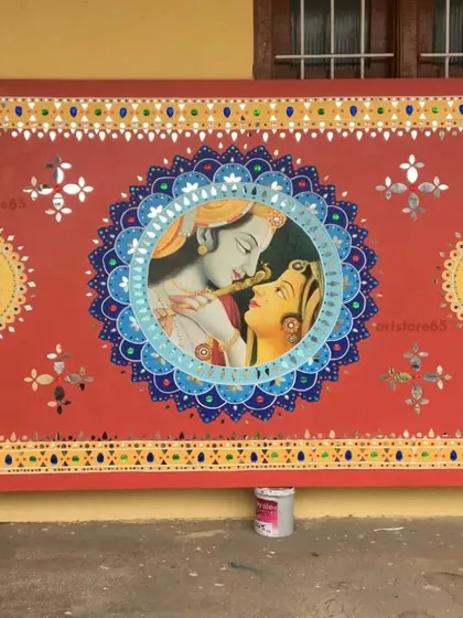 Here is the finished Radha-Krishna themed Lippan art panel, ready for installation. The rich red background, intricate mandala border, and central portrait create a piece filled with color, detail, and cultural significance.