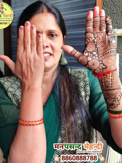 A happy client showcasing her beautiful full-hand design. Her smile is a testament to the quality of our work and service.