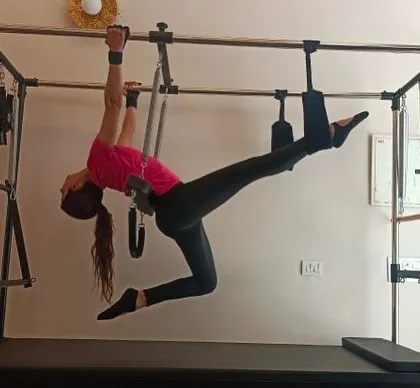 This image showcases a client's amazing flexibility and strength. Pilates is a journey of discovering what your body is capable of.