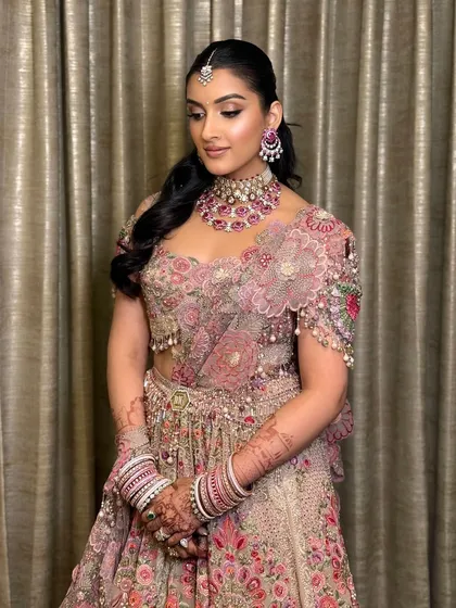 A full view of Mehak's stunning reception lehenga and makeup. The soft glam complements the intricate floral details of her outfit.