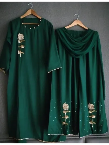 This elegant bottle green kurta and palazzo set is perfect for any festive occasion. The design is highlighted by a beautiful gold zari rose embroidery on the kurta and a gracefully draped dupatta with scattered embellishments.