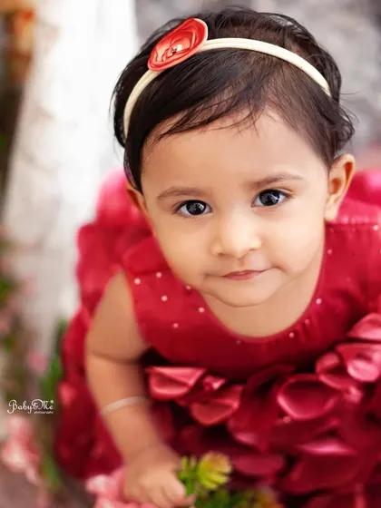 Those eyes! This close-up portrait captures her beautiful expression and the lovely details of her red floral dress.