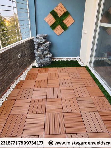 We use durable and water resistant Wood Plastic Composite (WPC) tiles for terrace and balcony flooring. They provide the look of wood without the maintenance, arranged here in a basket weave pattern.