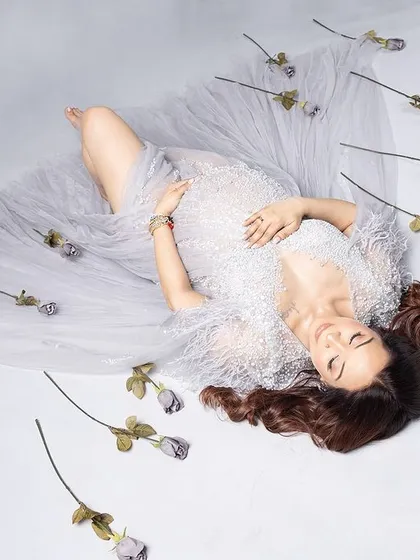 Simplicity is key. This artistic, top-down shot with a sheer white drape and scattered roses is beautifully minimalist and serene.
