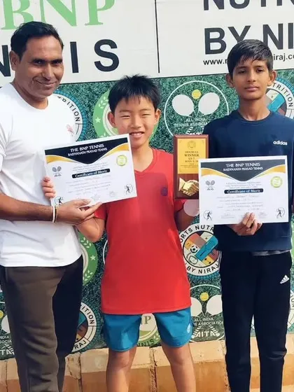 Toshi and his partner Aniket Singh with their U14 doubles winner trophies.