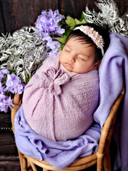 A side view of the rattan chair setup, showing the beautiful arrangement of flowers and fabrics.