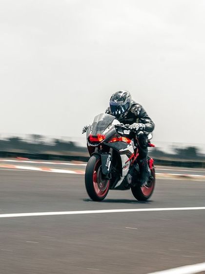 A rider on a KTM on the main straight.