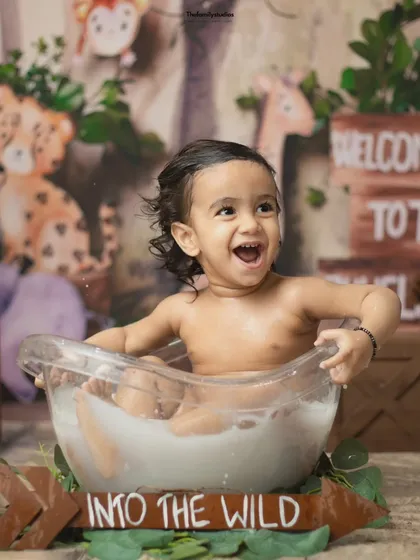 An explosion of joy during a jungle-themed milk bath session. These splash sessions are the perfect fun-filled ending to a first birthday or milestone shoot.