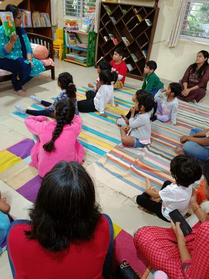 A full view of the "Singing Mermaid" story session, with children and parents enjoying the tale together.