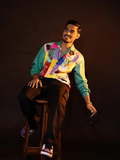 It was so much fun styling YouTuber Amit Sharma. This look features a vibrant, retro-style patchwork jacket that perfectly matches his energetic personality, making it great for on-camera appearances.