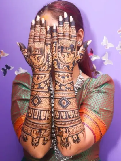 This heavy bridal mehendi is filled with classic motifs. The palms feature majestic elephants, while the arms are adorned with kalash figures and intricate geometric patterns.
