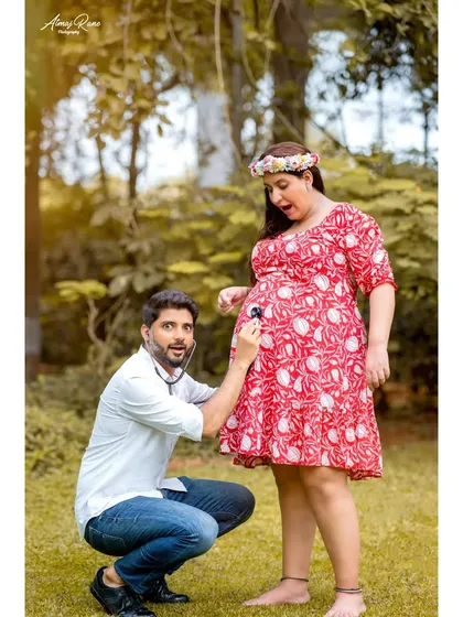 Maternity shoots can be full of fun and laughter too. This playful shot captures the dad-to-be listening to the baby bump with a stethoscope, bringing a lighthearted and personal touch to their pregnancy photoshoot.