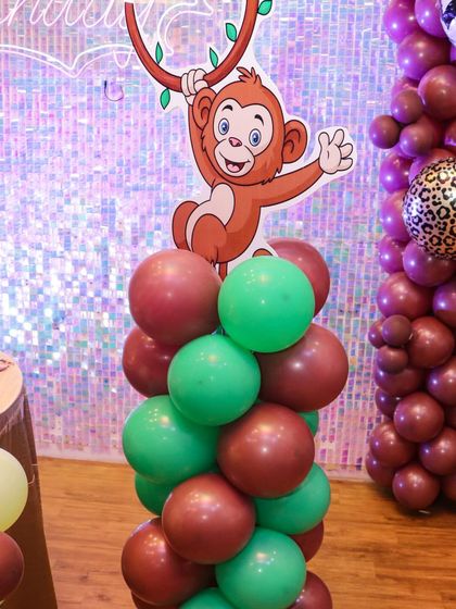 It's all in the details. This monkey character cutout on a balloon pillar adds a playful touch to our jungle and safari adventure themed parties.